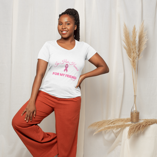 Woman wearing a white t-shirt with pink text and a breast cancer awareness ribbon, standing against a plain background.
