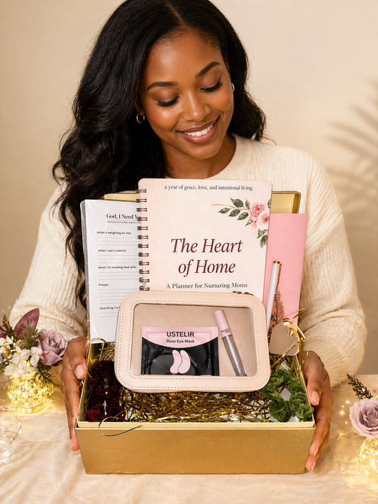 Woman holding a gift box with books and a pouch on a neutral background