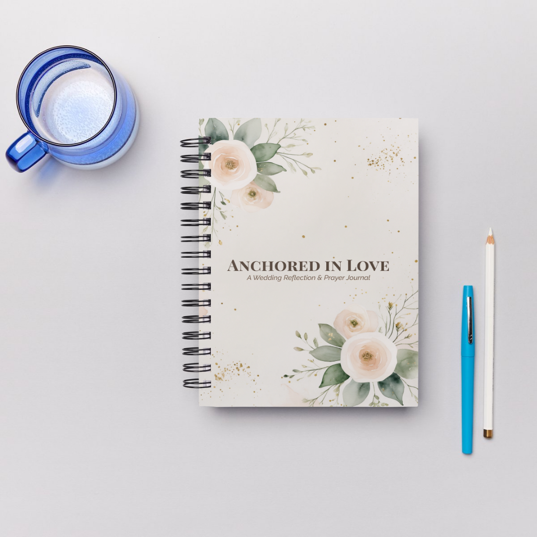 Notebook titled 'Anchored in Love' with floral design on a light gray background